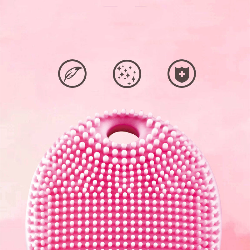 Close-up of pink Fashion Vibration Massage Cleaning Beauty Instrument showing soft silicone bristles for gentle and effective facial cleansing.